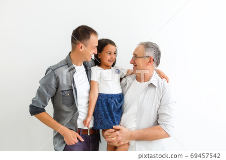 Indian asian family sitting over white background Indian asian family sitting over white background 69457542
