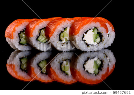 Fresh delicious beautiful sushi rolls on a dark background Fresh delicious beautiful sushi rolls on a dark background 69457691