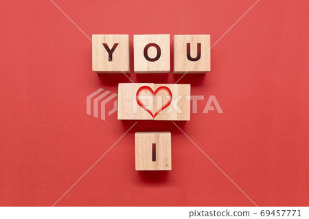 Wooden dice with a heart and the words I and YOU on a red background Wooden dice with a heart and the words I and YOU on a red background 69457771