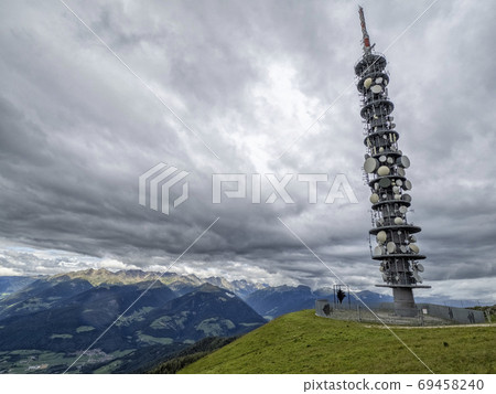 communication antenna in top of dolomites mountains communication antenna in top of dolomites mountains 69458240