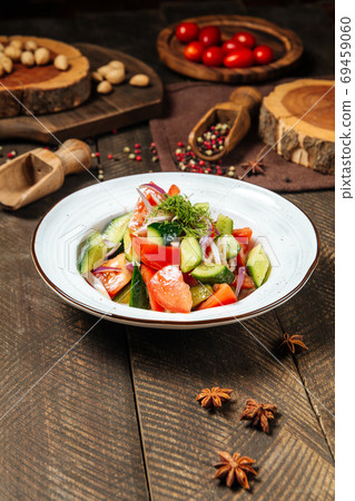 Fresh vegetables salad with tomatoes and cucumbers Fresh vegetables salad with tomatoes and cucumbers 69459060