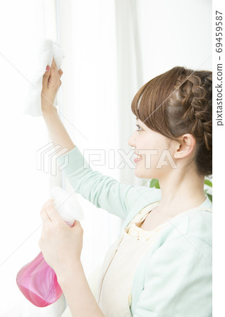 Woman cleaning the window Woman cleaning the window 69459587