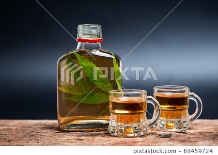 Alcoholic drink infused with marijuana product closeup Alcoholic drink infused with marijuana product closeup 69459724
