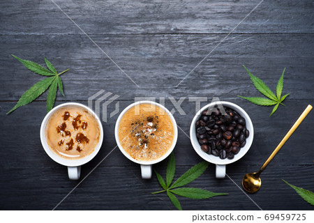 Cup of coffee with marijuana, roasted beans top view with Cup of coffee with marijuana, roasted beans top view with 69459725