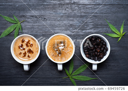 Cup of coffee with marijuana, roasted beans top view with Cup of coffee with marijuana, roasted beans top view with 69459726