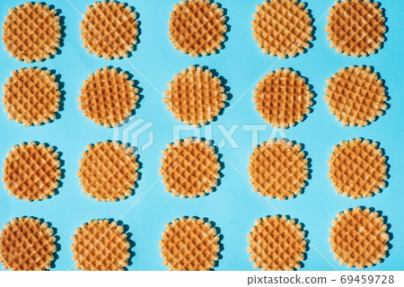 Belgium style waffles on blue background pattern flat lay Belgium style waffles on blue background pattern flat lay 69459728