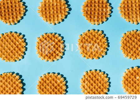 Belgium style waffles on blue background pattern flat lay 69459729
