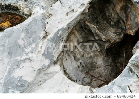Closeup rock pattern with hole in nature 69460424