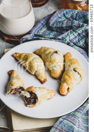 Croissants stuffed with nuts and chocolate for breakfast Croissants stuffed with nuts and chocolate for breakfast 69460718