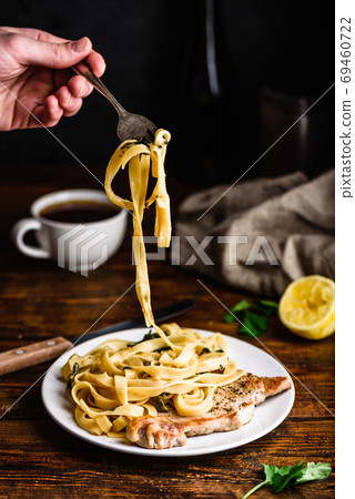 Pork chop steak with tagliatelle and capers Pork chop steak with tagliatelle and capers 69460722