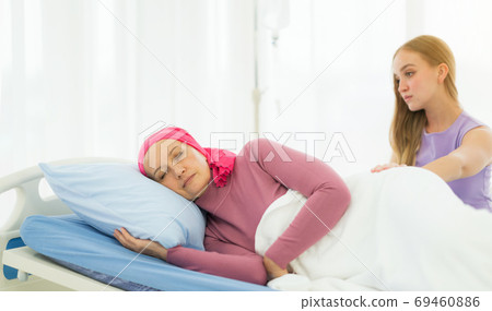 Young adult female cancer patient spending time with hug her dau Young adult female cancer patient spending time with hug her dau 69460886