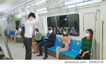 Crowd of people wearing face mask on a crowded public subway train travel 69462038