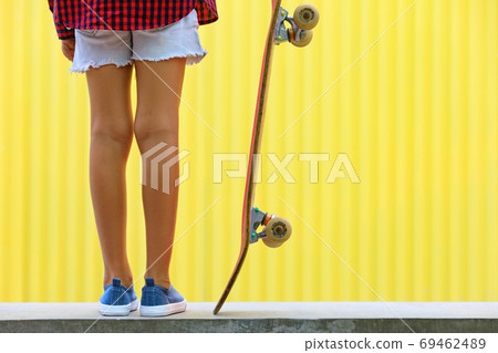 Close up view of skateboarder legs, sneakers, skateboard. Close up view of skateboarder legs, sneakers, skateboard. 69462489