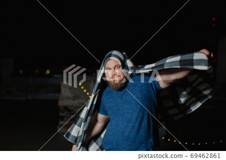 Big bearded man covered with a blanket. Big bearded man covered with a blanket. 69462861