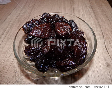 Dried plums in a bowl Dried plums in a bowl 69464181