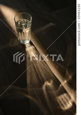 A glass of water and Sunrays A glass of water and Sunrays 69464280