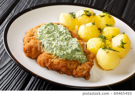 Delicious German food schnitzel with boiled new potatoes and the 69465493