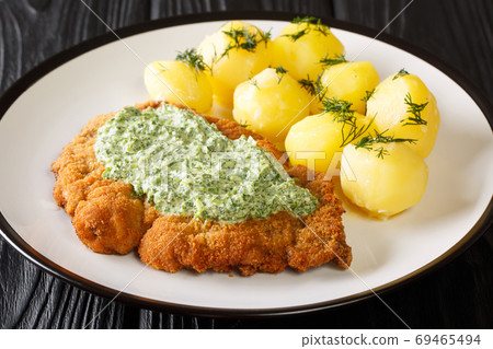 Breaded schnitzel with boiled potatoes and Frankfurt green sauce 69465494