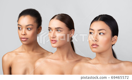 Portrait of three millennial girls posing shirtless standing in studio Portrait of three millennial girls posing shirtless standing in studio 69465572