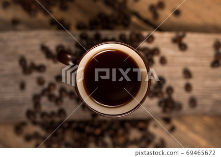 Coffee and coffee beans on old rustic wood table 69465672