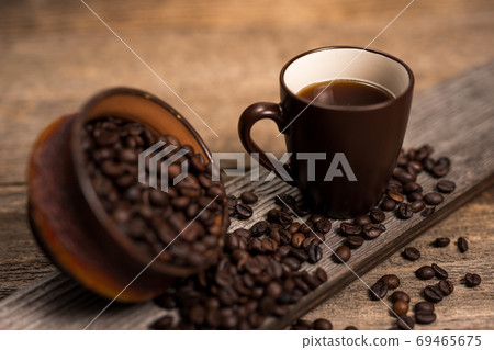 Coffee and coffee beans on old rustic wood table 69465675