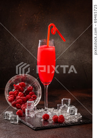 Delicious cold refreshing smoothie drink in cocktail glass with raspberry Delicious cold refreshing smoothie drink in cocktail glass with raspberry 69465725