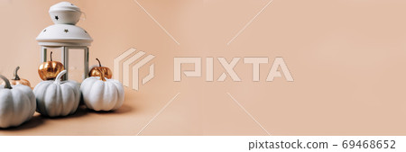 Autumn layout with pumpkins on a rose background Autumn layout with pumpkins on a rose background 69468652