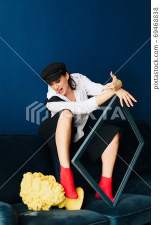 Portrait of a beautiful young woman in a white shirt and black pants in the Studio 69468838