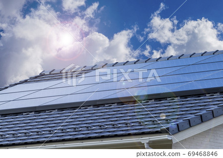 Eco-house, solar panels and blue sky_backlit version 69468846