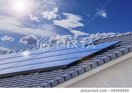 Eco-house, solar panels and blue sky_backlit version 69468880