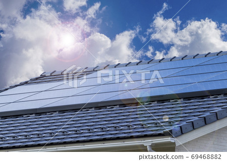 Eco-house, solar panels and blue sky_backlit version 69468882