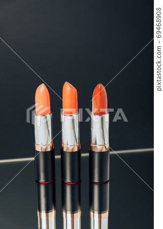 Lipstick in different colors on a dark background 69468908