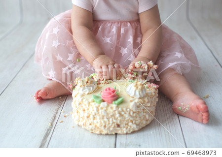 First baby birthday. Balloon garland on background. Disgruntled kid 69468973
