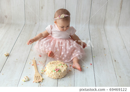 First baby birthday. Balloon garland on background. Disgruntled kid 69469122