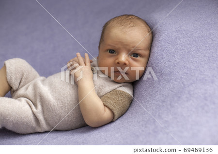 Newborn baby boy on blue textile background. Newborn baby boy on blue textile background. 69469136