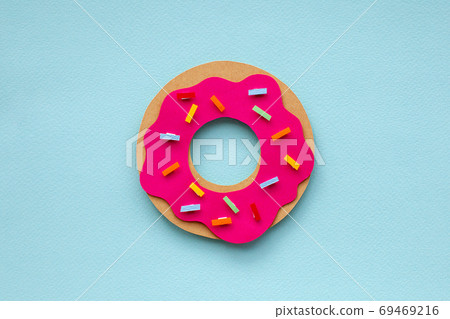 Colorful paper cutout strawberry donut on blue background. Colorful paper cutout strawberry donut on blue background. 69469216