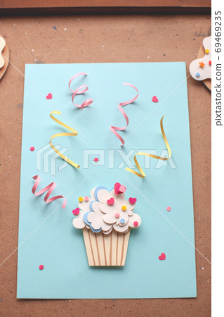Paper cutout cupcake with confetti. Backstage. Paper cutout cupcake with confetti. Backstage. 69469235