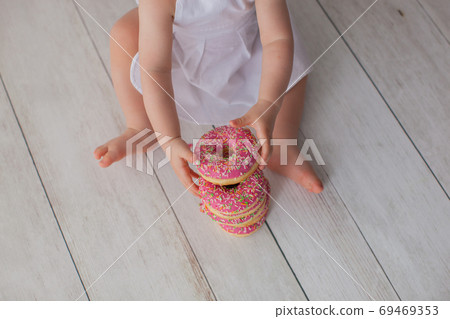 One year old baby girl celebrates her birthday. Close up.  69469353