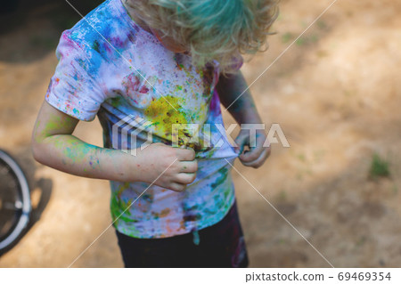 Colorful powder color on shirt, indian festival. Colorful powder color on shirt, indian festival. 69469354