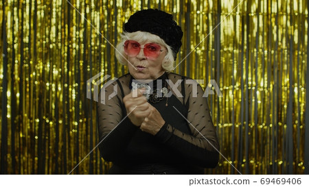 Senior old woman asking to stop and showing restrict gestures with hands displeased with something Senior old woman asking to stop and showing restrict gestures with hands displeased with something 69469406