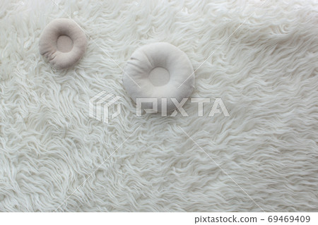 Newborn props on white faux fur. Newborn props on white faux fur. 69469409