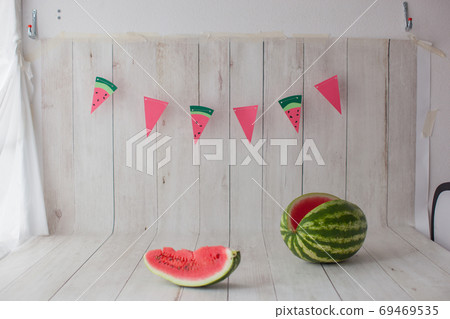 Photo zone with watermelon and garland. Photo zone with watermelon and garland. 69469535