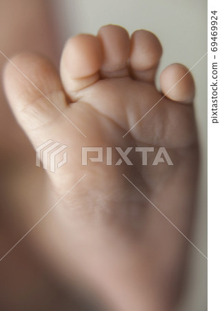 Foot of a newborn baby. 69469924