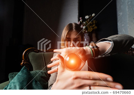 Woman in business suit holding crystal ball 69470660