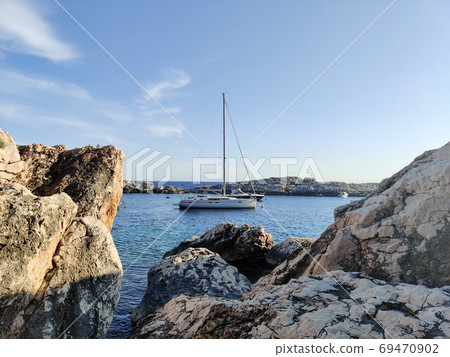Sailboat mooring in a small cove of beach Velo Zarace on Hvar island, Croatia in sunset Sailboat mooring in a small cove of beach Velo Zarace on Hvar island, Croatia in sunset 69470902