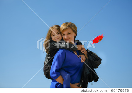 Happy mother and daughter hugging each other Happy mother and daughter hugging each other 69470976