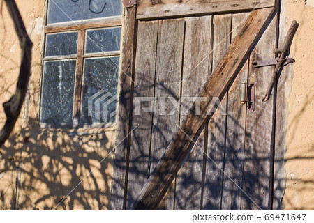 The wall and door of an old clay house. The wall and door of an old clay house. 69471647