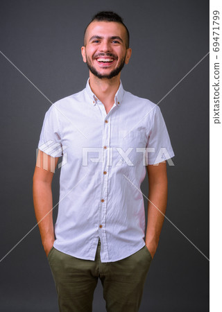 Portrait of happy handsome bearded Turkish man smiling Portrait of happy handsome bearded Turkish man smiling 69471799