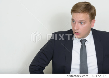 Portrait of businessman with blond hair wearing suit Portrait of businessman with blond hair wearing suit 69472116