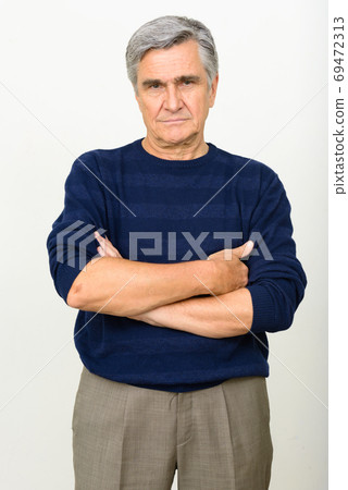 Portrait of handsome senior man with arms crossed Portrait of handsome senior man with arms crossed 69472313